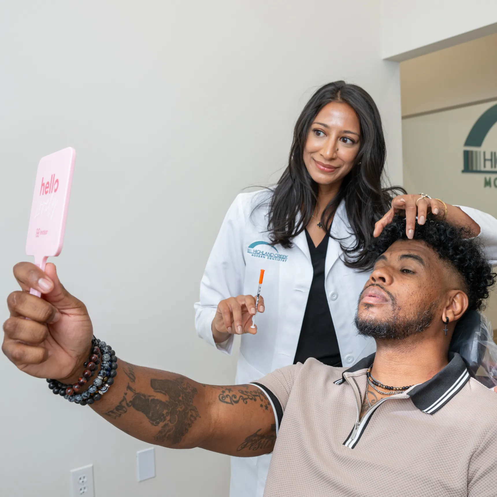 Dr. Bijal Patel and patient looking results at the mirror